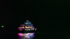 Stock Video Footage 1920x1080 1080p hdv Pleasure Boat Goes To Night Seascape. Boat Decorated With Lights Turns And Leaves The Sea At Night. Tourists, People Are Have A Rest. Sea Vacation Travel Asia.