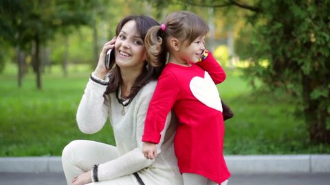 Mother and child talking on the phone
