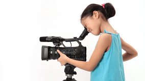 Little girl operates a video camera