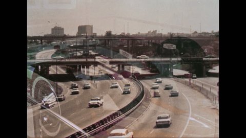 UNITED STATES - CIRCA 1970s: Busy highway. A POV perspective from the hood driving down the highway. Man drives car through a suburban neighborhood. VW Beetle drives through a suburban neighborhood.