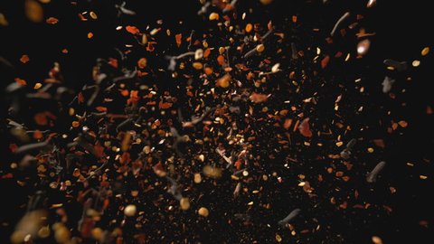Camera follows spices flying after being exploded against white background. Slow Motion. Shot with high speed camera, phantom flex 4K. Slow Motion. Unedited version is included at the end of clip.