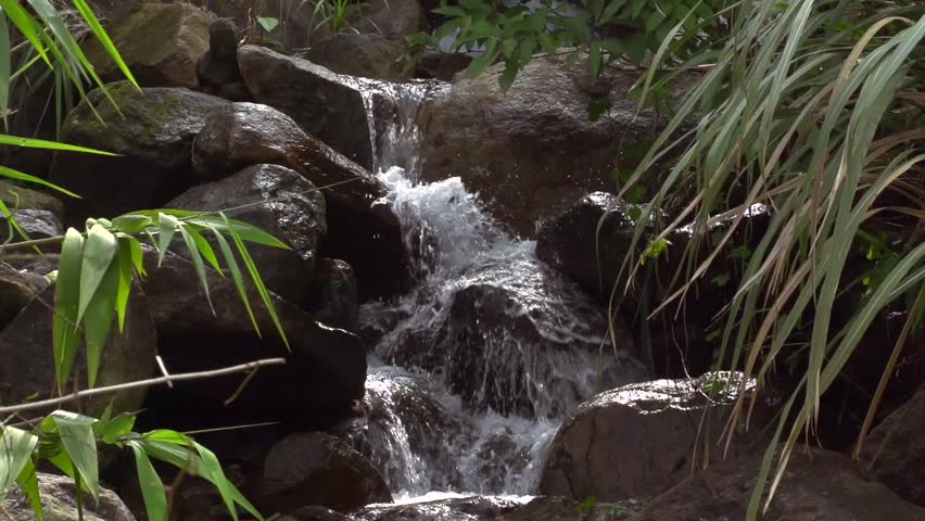 Slow motion mid shot of small waterfall. Shot in the Bình nh province, Vietnam.