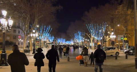 BARCELONA, SPAIN - DECEMBER 30 2014: La Rambla is a crowded street in central Barcelona, popular with tourists and locals alike. A tree-lined pedestrian mall, it stretches for 1.2 kilometres (0.75 mi).
