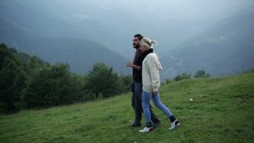 Young beautiful romantic couple is walking outdoor on mountain - HD video footage