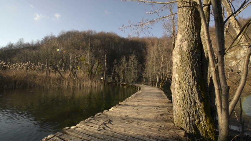 Walking on boarwalk throughout Unesco word heritage plitvice lakes national park waterfall - HD video footage
