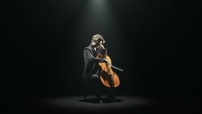 Cellist is tuning his cello alone on stage - HD video footage