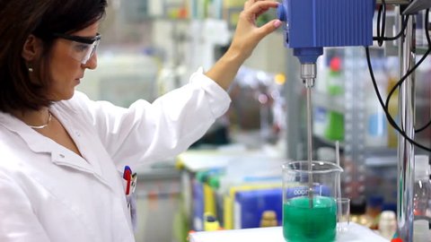 Chemist Engineer - Laboratory.
Chemist woman works with lab mixer and mixing chemicals in laboratory.