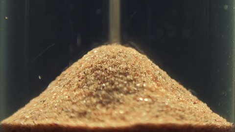 Super Close-up View of Sand Flowing Through an Hourglass. Full HD 1920x1080 Video Clip