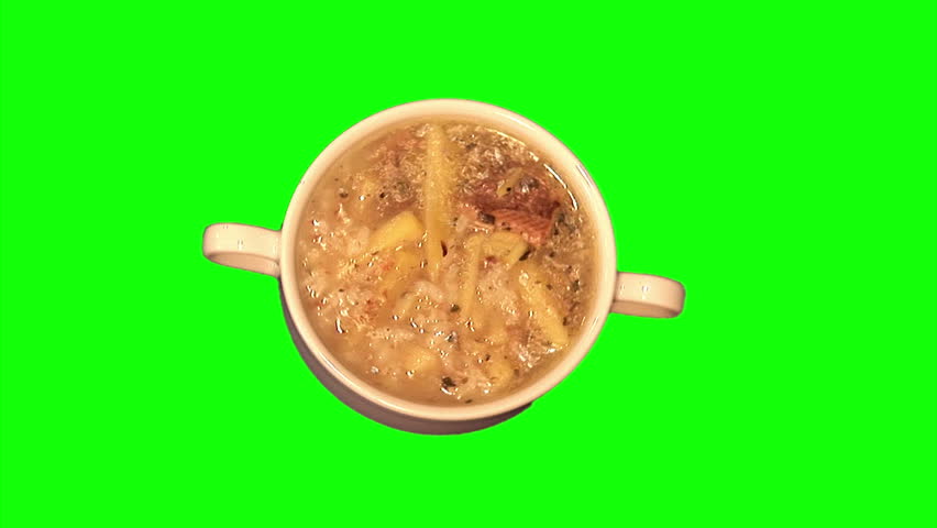 Fish soup in bowl rotating on green screen, loop, top shot 