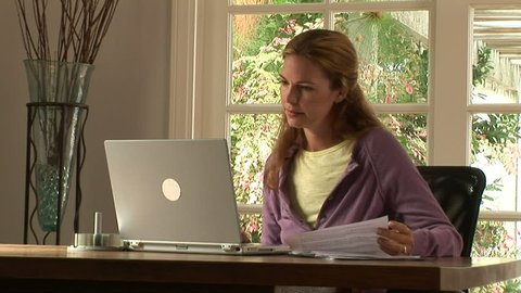 Young woman stressed while working at home with laptop