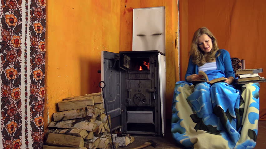 young girl found an interesting book and read comfortably tucked in the soft armchair to the furnace in the village. Shot on Canon XA25. Full HD 1080p. Progressive scan 25fps. Tripod
