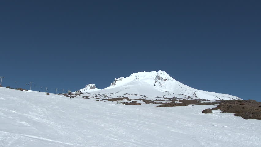 4K - Snowmobile speeding up Mt Hood in Oregon on clear day.
