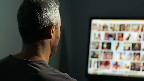 man watches surfing nude sexy girls on the web net looking for virtual sex at night in a dark room,screen is out of focus uhd 4k,useful to represent internet easy porn accessibility and social issue