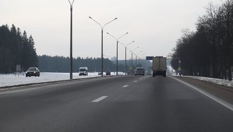 Shooting from the car traffic on the highway trucks. Belarus,Minsk,February,02,2015
