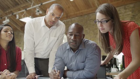4K Mixed ethnicity business team in strategy meeting in modern office Video Stok