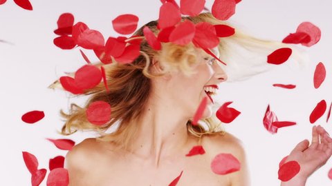 Beautiful woman smiling in falling rose petals Red Epic Dragon