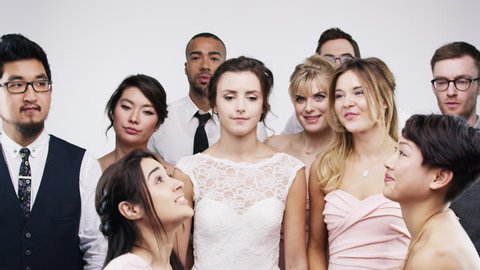 Multi ethnic group of friends dancing slow motion wedding photo booth series