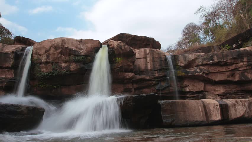 Time lapse mountain stone waterfall and cloudy