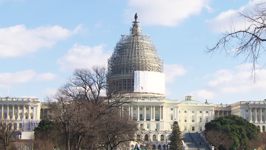 Wide exterior of The United States Capitol building under construction. Shot in 1080p HD.