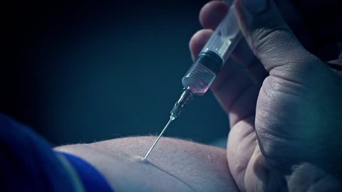 Male addict injects a syringe into a vein. Heroin or meth. Social degradation, self-destruction of narcomaniac junkie. Real blood and prick clip footage. 