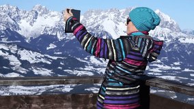 Woman hiker taking photo with digital tablet, Alps, Austria