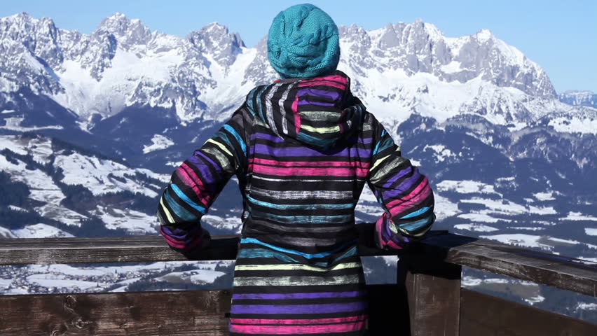 Woman standing on mountain peak with arms outstretched, Alps, Austria 