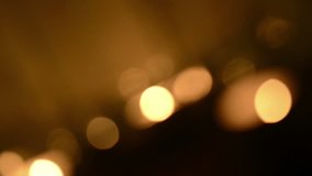 Rotating background blur of candles burning with defocused bokeh effect