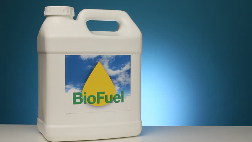 A container of refined biofuel sits next to a beaker of raw corn that is used to