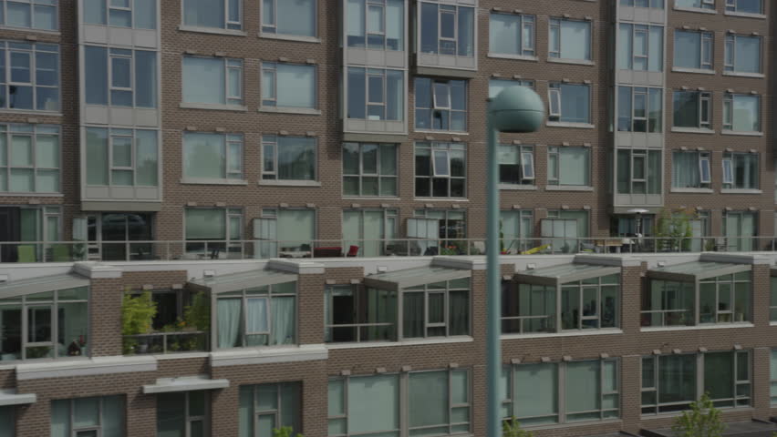 Dolly shot from bridge of city high rises and streets below.
