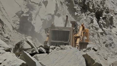 HIMACHAL PRADESH, INDIA - JUNE 30, 2012: Bulldozer cleaning mountain road after landslide in Himalayas. 