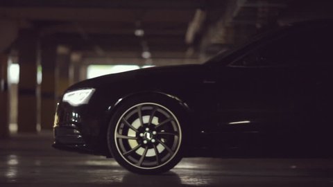 Black Audi leaves the parking lot with its lights on HD 1080p