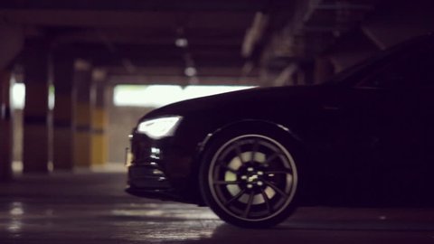 Black Audi leaves the parking lot with its lights on HD 1080p