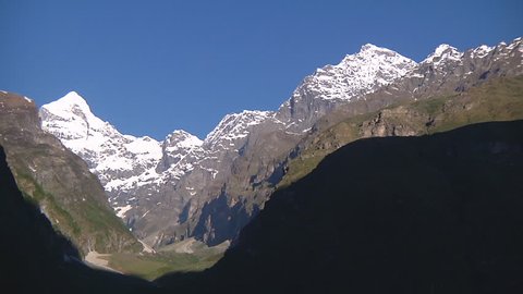 Wide Shot of snowy mountains and the valley at Badrinath in Uttarakhand, India