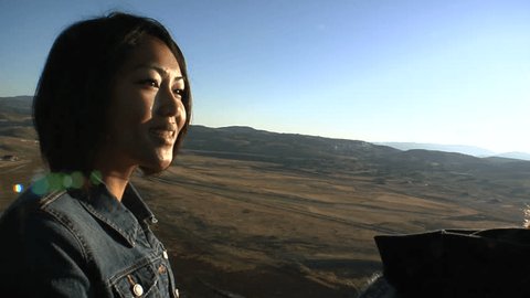 Asian woman looks out from balloon ride. Stock Video