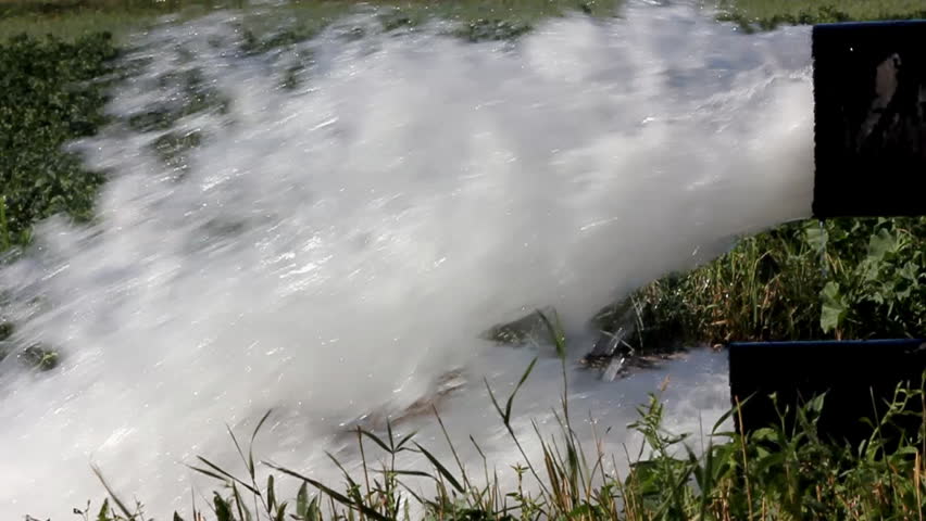 strong jet of water flowing from a large pipe - slow motion