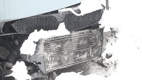 broken in the accident car covered with snow radiator and hood