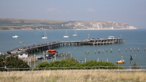 Swanage harbour pier and jetty Dorset England UK with sea and coast on a beautiful summer day