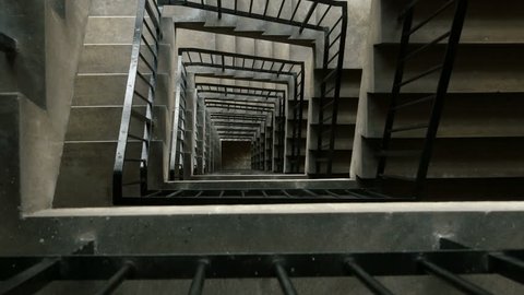 High rise concrete stairwell tracking shot.
Camera tracks out over the railing of a multi storey stairwell.
