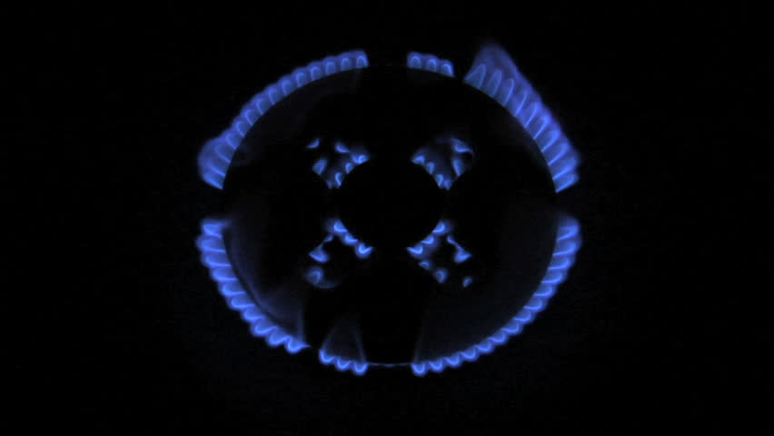 Blue flames of gas stove on the black background 