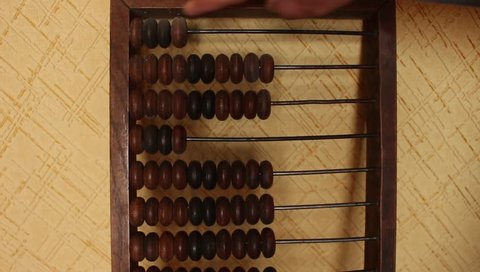 Man uses vintage old abacus