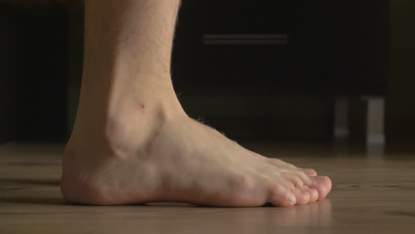 4k UHD - Young male feet getting out of bed