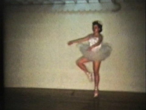 A beautiful teenage girl wearing a pretty princess ballerina dress demonstrates ballet en point at her recital. Stock Video