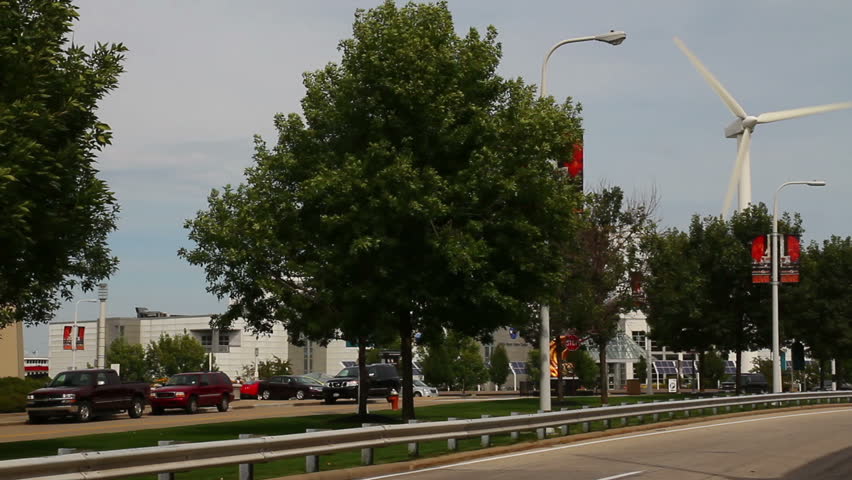 Cars pass by the windmill at the Great Lakes Science Center on the shore of Lake