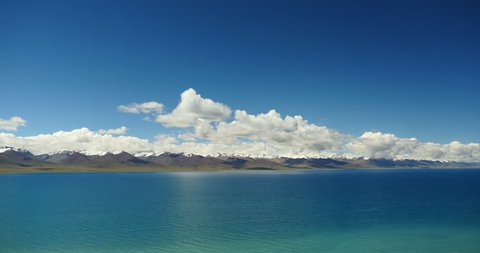 4k time lapse of huge clouds mass rolling over lake namtso & Tanggula snow mountain peak,tibet mansarovar,Tibet's second largest lake,is the third largest saltwater lake in China.gh2_09454_4k