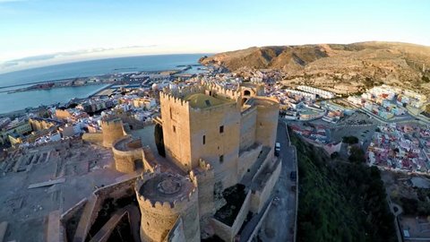 Muslim and Christian fortress in Almeria - Alcazaba. 4k Ultra High Resolution Aerial footage during sunset. flying over the spanish old town costa blanca, andalusia