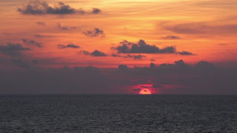 Sun setting into ocean and hiding behind horizon.  Goa, India