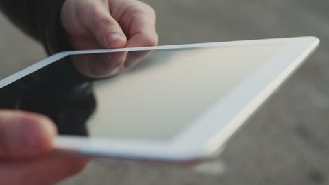 Close up of man hand touching digital tablet.