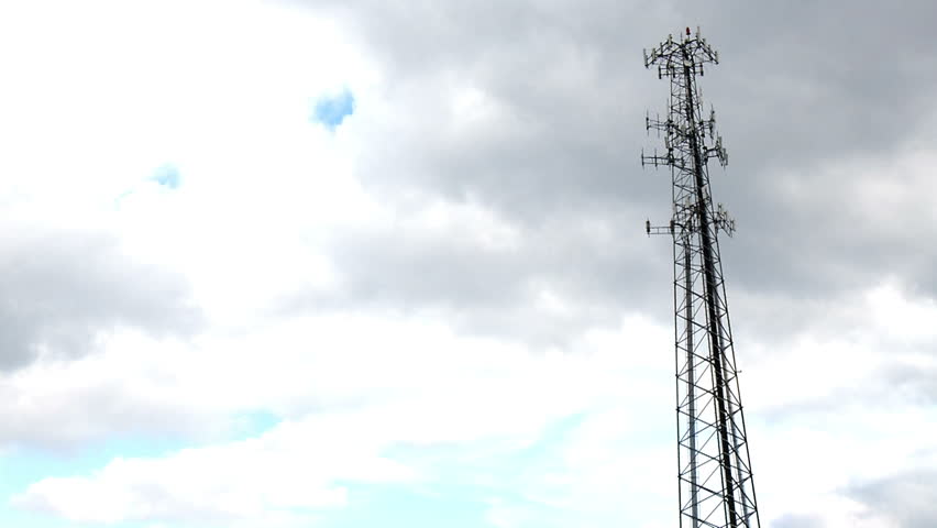Time lapse clouds above a cellular tower.