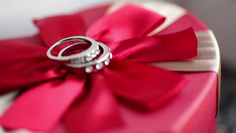 Wedding rings on a red bow

