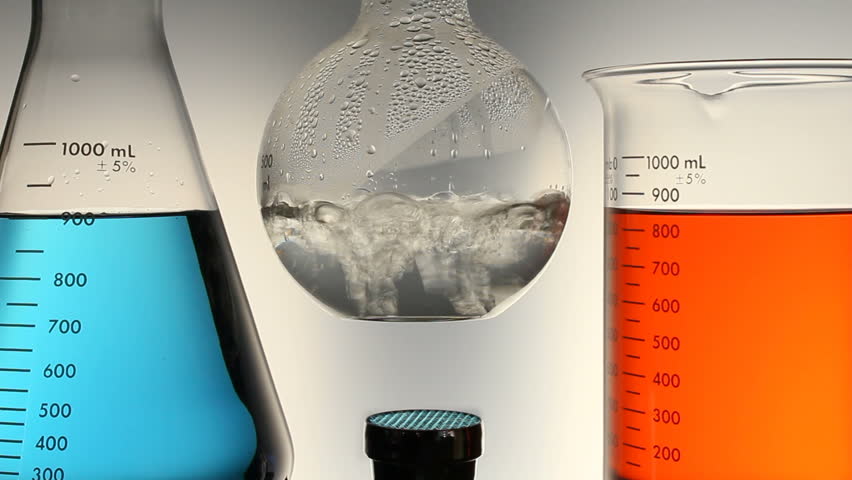 A boiling flask is positioned over a bunsen burner, with boiling liquid in a lab